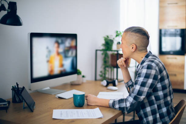 istock Woman following online courses on her computer at home 2200525584