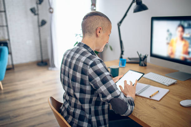 istock Woman having a remote lesson online at home on a computer 2200525677