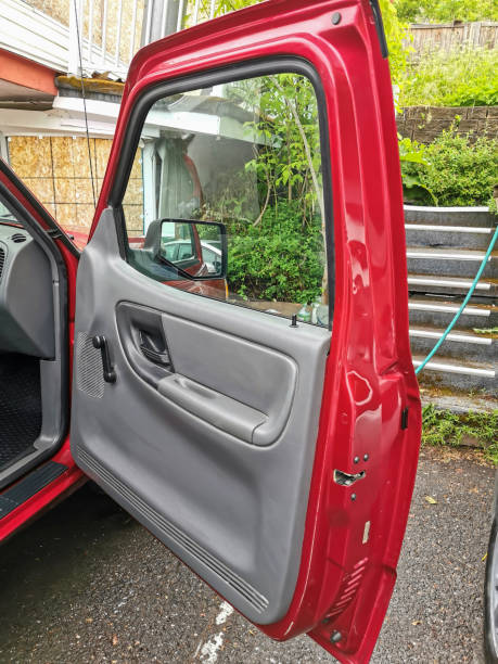 istock Open Red Truck Door Showing Interior Panel and Window in Outdoor Setting 2200526025