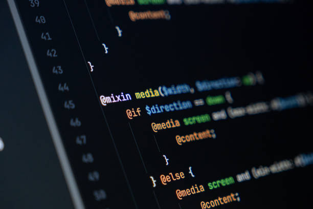 istock close-up of computer screen with colorful sass code, focus on mixin and media queries, web development and frontend design 2200527143