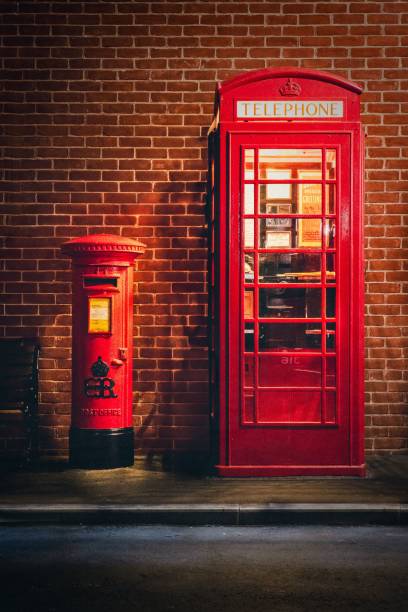 istock Classic red British telephone booth and postbox at night. 2200527411