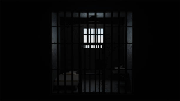 istock 3D model of a solitary prison cell behind bars with a bed and a table and a window with light 2200530013