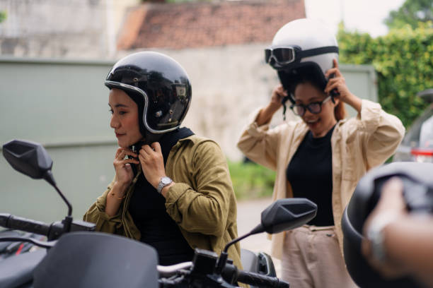 istock Muslim Women Putting on Helmets Before Riding Motorbikes 2200530518