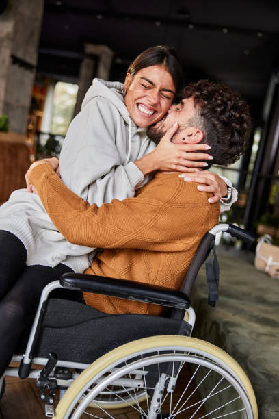 istock Loving woman embracing her disabled boyfriend. 2200530625