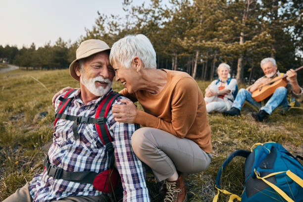 istock Happy mature backpackers embracing on a break in nature. 2200531771