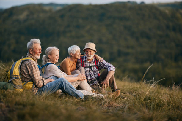 istock Happy mature backpackers relaxing on a break in nature. 2200531912