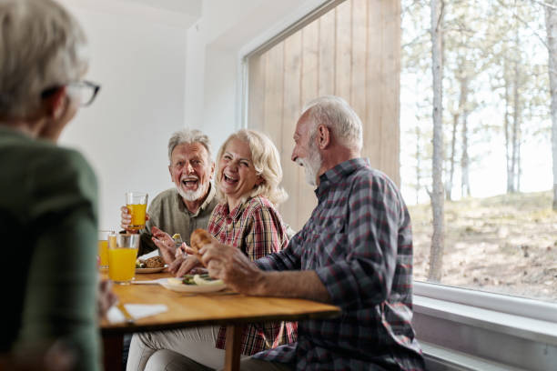 istock Cheerful senior friends talking during breakfast at home. 2200532147