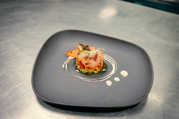 istock Chef plating gourmet dish in a professional kitchen 2200532236