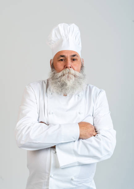 istock Senior old man cooking chef with gray beard portrait in studio 2200537209