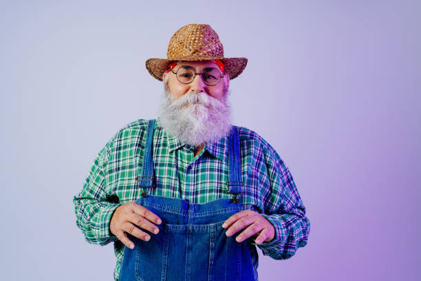 Portrait of cheerful young man in a cowboy costume dancing during a Halloween party with friends. He is looking at camera, smiling with confidence.