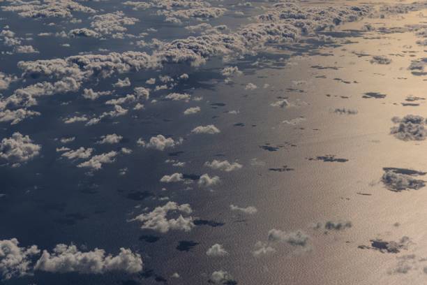 istock Aerial view of clouds over a shimmering ocean. 2200537600