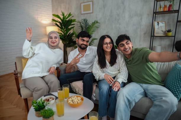 istock Four friends taking a selfie while watching TV and having snacks 2200539054
