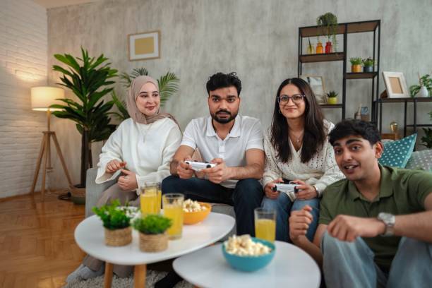 istock Four Young Adults Playing Video Games at Home 2200539291