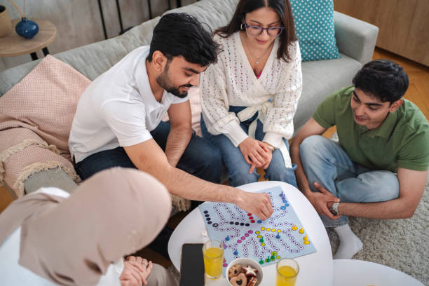 istock Group of young adults playing board games at home 2200539500
