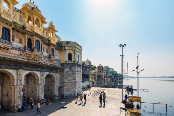 motion blurred people at Gangaur Ghat in Udaipur at sunny day under blue sky