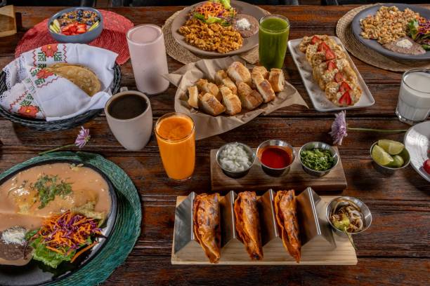 istock Mexican breakfast spread with tacos, enchiladas, fresh juices, and coffee. 2200541441