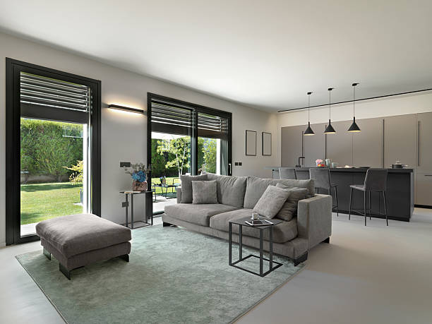 istock Modern Living Room with Sofa, Footrest, and Kitchen View 2200541940