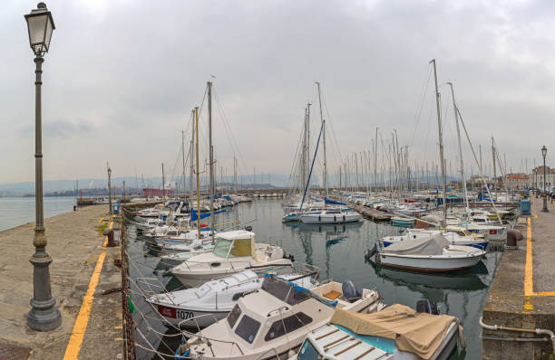 Trieste, Italy - January 12, 2017: San Rocco Marina for Sailing Vessels and Small Boats at Muggia Port Cold Winter Day.