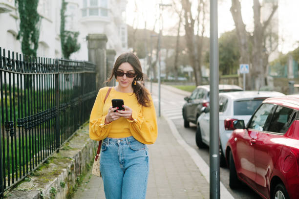 istock Young woman using a smart phone 2200543378