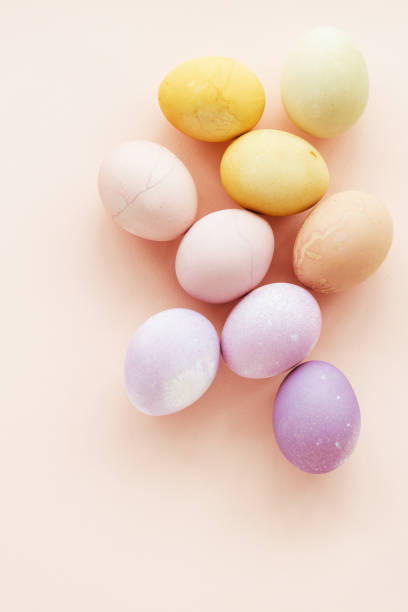 istock Natural dying colorful Easter eggs on peach background. 2200543416