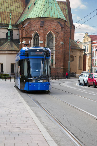 istock Modern 18 Krakow tram passing historic church 2200545597