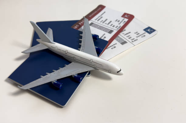 istock Toy airplane and passport with tickets on gray background, top view 2200546241