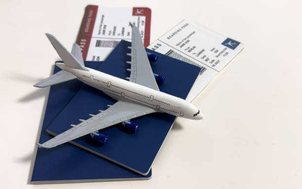 istock White blank model of passenger plane on passports with boarding pass 2200546349