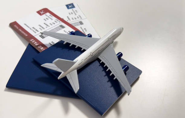 istock White blank model of passenger plane on passports with boarding pass 2200546399