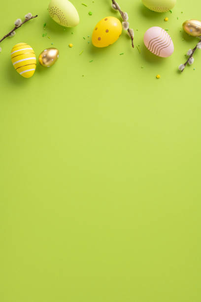 istock Easter-themed vertical composition featuring decorative eggs and pussy willow twigs on a green surface 2200546827
