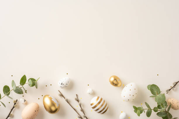istock Easter decoration featuring ornamental eggs, natural tree branches, and foliage over a neutral surface 2200546861