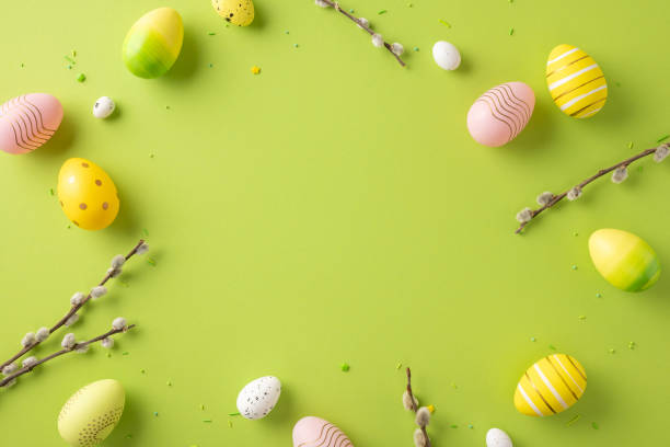 istock Cheerful image of colorful Easter eggs with spring branches on a vibrant green backdrop 2200546867