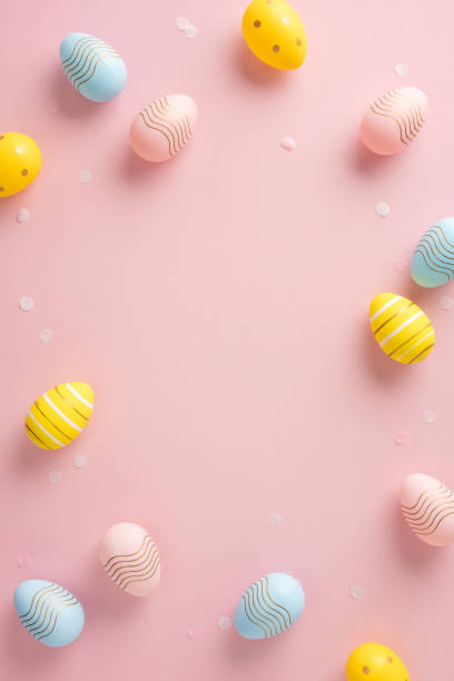 istock Colorful vertical Easter eggs arranged on a soft pink background, evoking festive cheer 2200546887