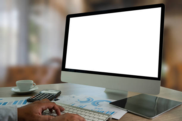 istock A businessman is using a modern laptop on a white desk in a bright office, typing on a keyboard while viewing a blank screen, showcasing technology and communication. 2200548508