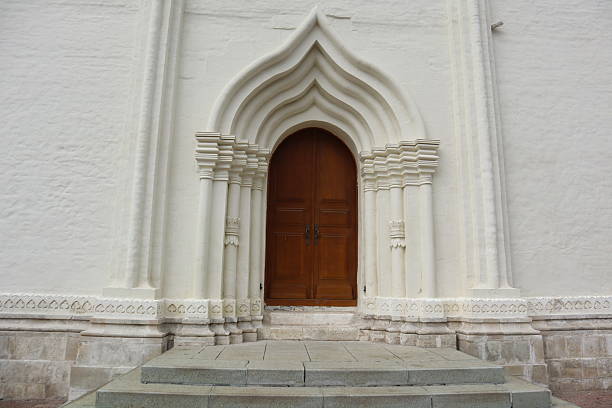 Entrance to an ancient church with a white wall