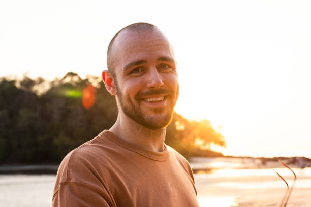 istock Carefree man at beach during sunset 2200550901