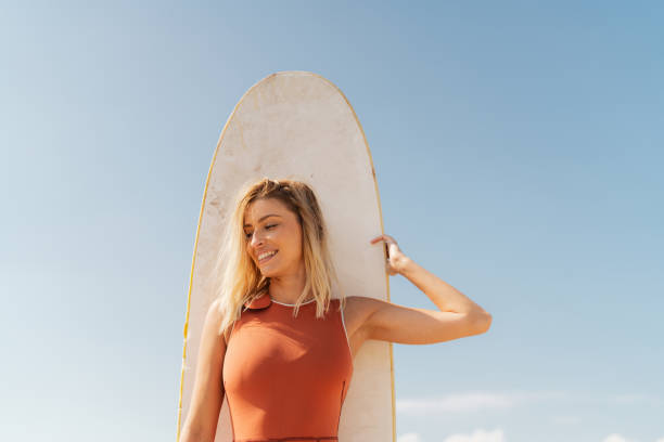 istock Surfer girl and her surfboard 2200551156