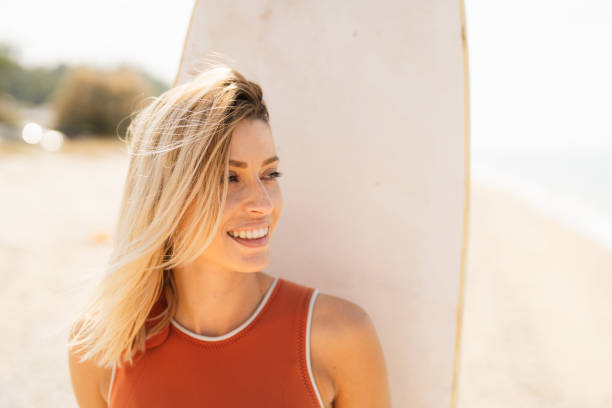 istock Surfer girl and her surfboard 2200551199