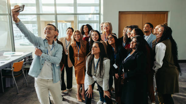 istock Team photo capturing unity and professional growth during an office gathering. Colleagues share a moment of togetherness and joy, emphasizing a collaborative and supportive work environment. 2200552163