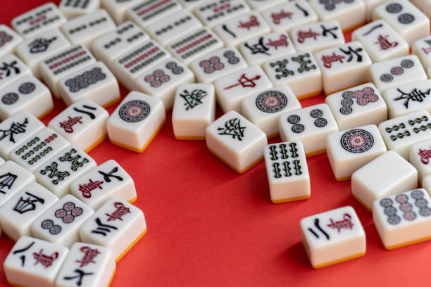 istock Mahjong tiles lined up on a red background 2200553006