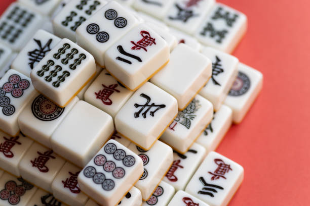 istock Mahjong tiles stacked on a red background 2200553105