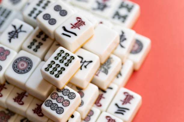 istock Mahjong tiles stacked on a red background 2200553138
