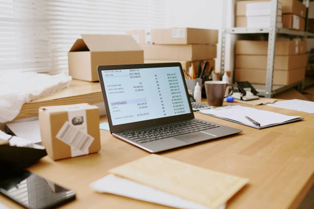 istock Organizing Workspace with Shipping Boxes and Laptop 2200553377