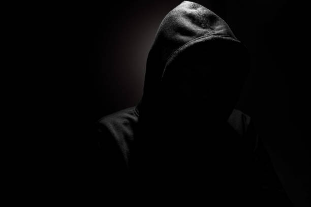 istock Hacker in hoodie planning a cyber attack in darkness, internet security threats and cyber crime concept 2200555395