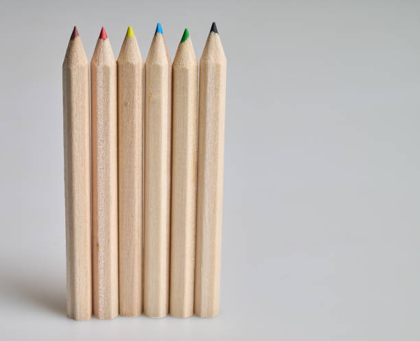 istock Six raw wooden colored pencils on white background 2200556017