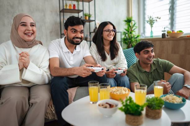 istock Four friends playing video games and having fun at home 2200556049