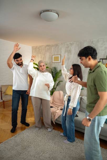 istock Four Young Adults Dancing Together in a Living Room 2200556086