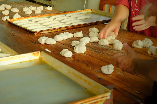 ฺBread shaping by worker in homemade bakery at local province of Thailand close up selective focus