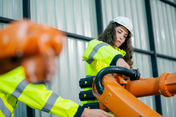 istock Engineer conducts maintenance on robotic arm in modern industrial facility during daylight hours 2200557569
