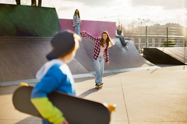 istock Girl on a skateboard whit her friends 2200557890