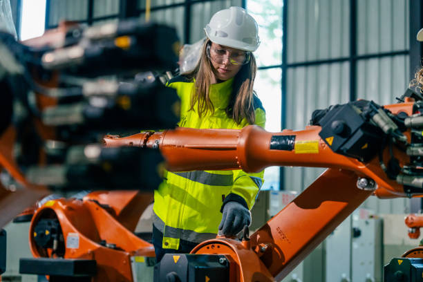 istock Engineer operates robotic arm in modern manufacturing facility during daylight hours 2200558995